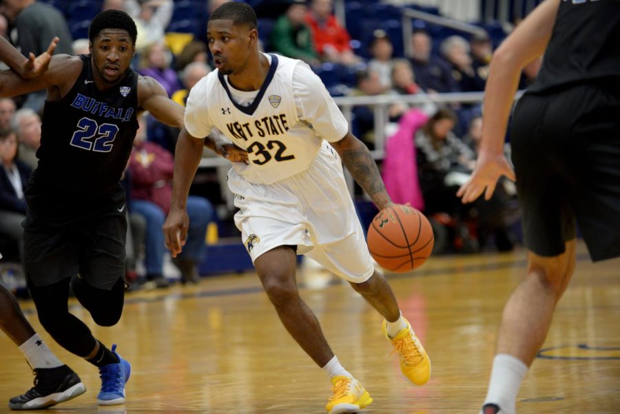 Kent State junior Desmond Ridenour takes the ball down the court while guarded by University at Buffalo sophomore Dontay Caruthers on Tuesday, Jan. 17, 2017, at the Kent State M.A.C. Center. The Flashes lost, 69-82.