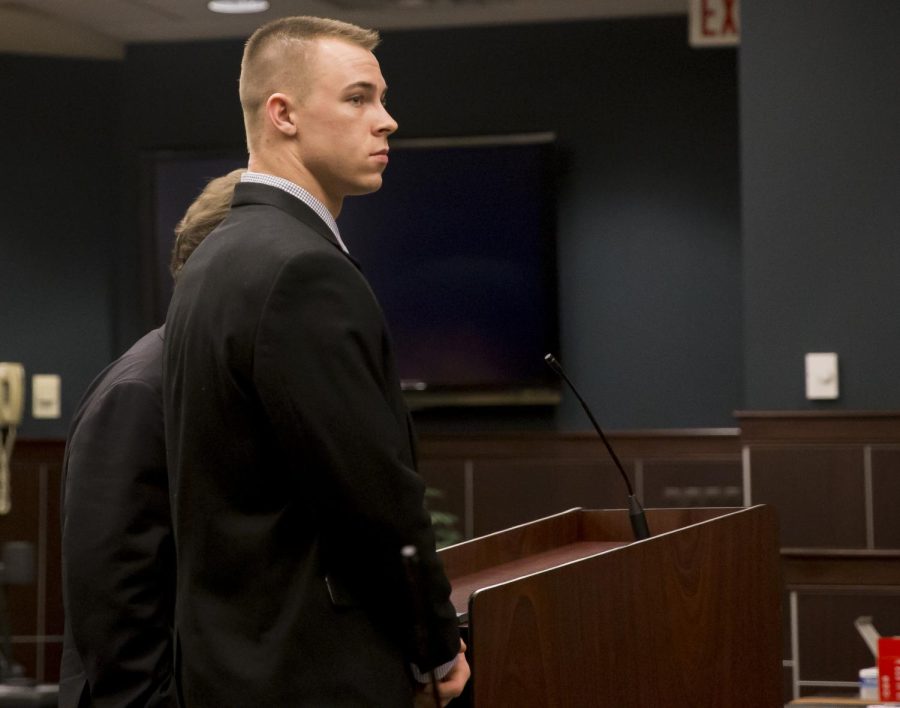 Former Kent State football player Nate Holley stands with his attorney during his pretrial hearing at the Portage County Municipal Courthouse in Ravenna, Ohio, on Wednesday, Jan. 18, 2016. Holley has been charged with felony kidnapping and felonious assault.