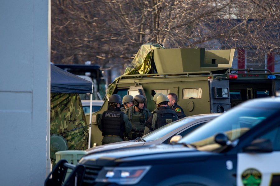 SWAT stands at the back door of building 5 at the villages at Franklin Crossings during a hostage situation on Sunday, Feb. 19, 2017.