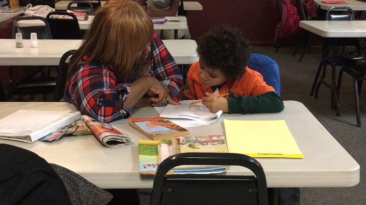 Volunteer Cynthia Alexander helps student Byron Ridenour-Wright with homework during a "Homework Help" session at Kent Social Services.