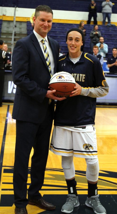 Kent State's head coach Todd Starkey and senior guard Larissa Larken pose for photos on Wednesday, Nov. 30, 2016 after Larken was honored for scoring her 1,000th career point in the previous game.