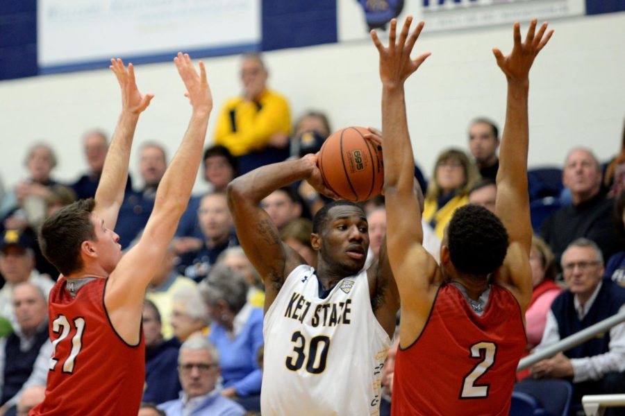 Kent State senior guard Deon Edwin looks to pass over Miami Redhawks red-shirt guard Jake Bischoff and junior forward Rod Mills Jr. at the M.A.C. Center on Feb. 14, 2017.