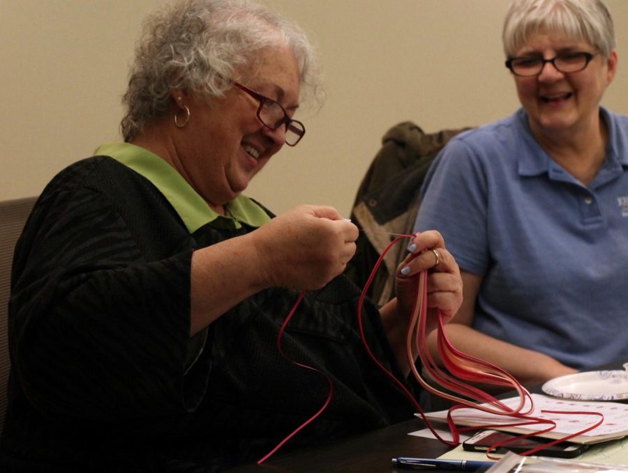 Jan Radar and Diana Ryman, attendees of the Women's Center's Quilling Workshop, put their skills to work during the event on Wednesday, Feb. 8, 2017. 