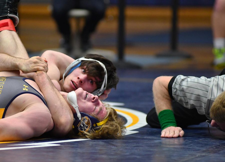 Kent State red-shirt freshman Jared Walker fights to avoid being pinned against Eastern Michigan red-shirt senior Devin Marry at the M.A.C. Center on Sunday Feb. 5, 2017.