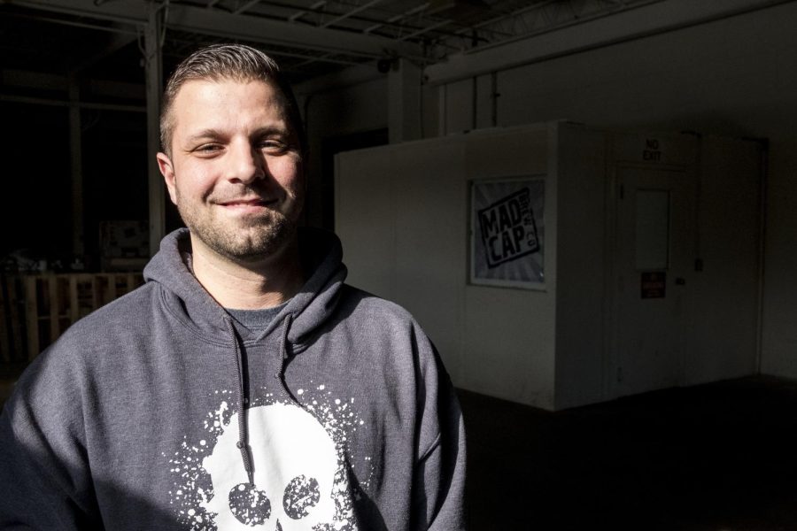 Ryan Holmes, owner of MadCap Brewery in Kent, Ohio, poses for a portrait in the windows of his brewery on March 10, 2017.