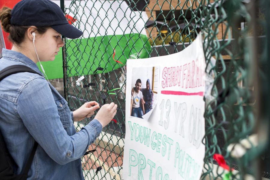 Freshman journalism major Madison MacArthur ties a ribbon to the fence as a sign of solidarity for Shadi Farah for the Israeli Apartheid Week in Risman Plaza on Monday, March 20, 2017. Farah is a 13-year-old boy serving a three-year prison sentence by the Israeli government. MacArthur was not aware about Shadi’s situation. “It’s just stuff that you don’t learn about, like I didn’t know about any of this," MacArthur said. 