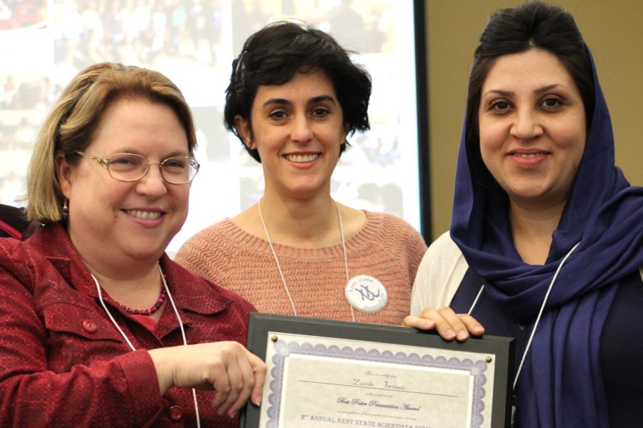 Lyric Aquino Scientista advisor Robin Sellinger presenting an award with Parastoo Maleki , the Scientista president to one out of three winners, Zeinab Parsouzi at the Scientista Symposium on March 8th, 2017.