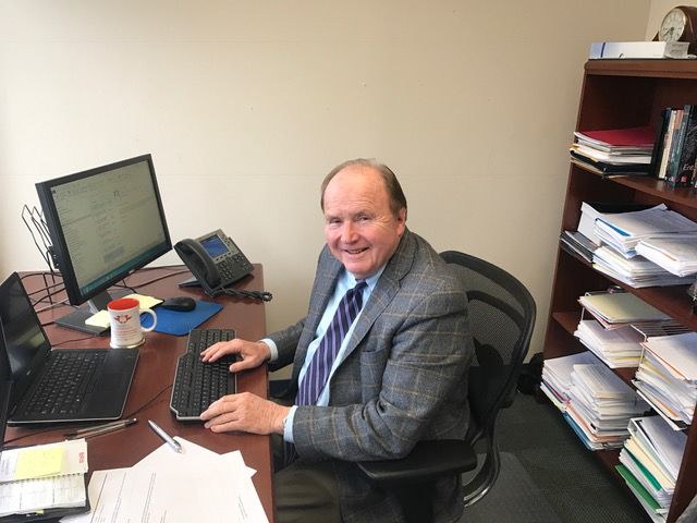 Robert Hisrich logs into his computer in his office in the Business Administration building. 