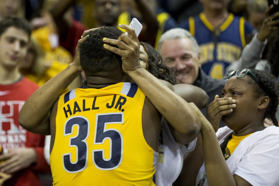 Kent State senior forward Jimmy Hall hugs his mom after beating Akron 70-65 in the MAC Title Game at Quicken Loans Arena in Cleveland, Ohio on Saturday, March 11, 2017. Hall was named to the All-MAC Tournament team.