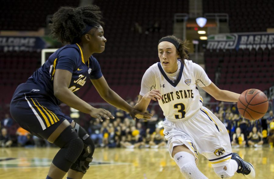 Kent State senior guard Larissa Lurken drives on Toledo senior forward Janice Monakana during the quarter-finals of the MAC Tournament at Quicken Loans Arena in Cleveland, Ohio on Wednesday, March 8, 2017. Kent State lost 67-63.