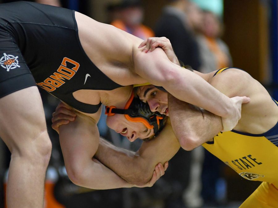 Kent State junior Stephen Suglio battles with Oklahoma Sate red-shirt sophomore Derek White during Kent State University's Beauty and the Beast double meet event for gymnastics and wrestling on Saturday, Feb. 4, 2017.