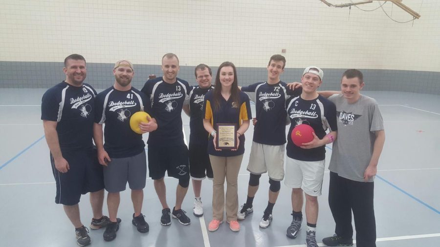 Cassandra Weaver, one of the captains on Kent State’s dodgeball club, stands with the winning team, "Old Guyz", of the dodgeball tournament fundraiser for alumni member Matthew Kelsey.