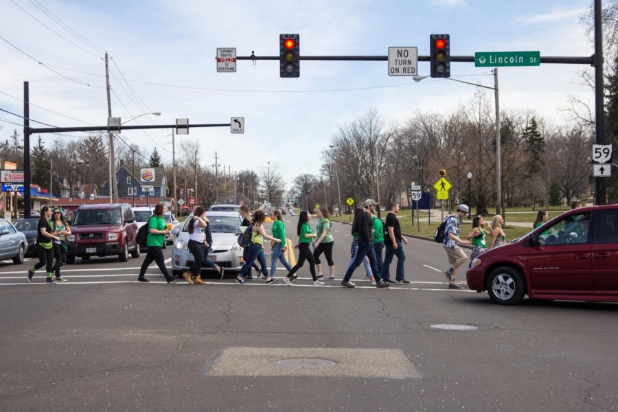 Students cross Main St. during Fake Patty's Day on Saturday March 12, 2016.