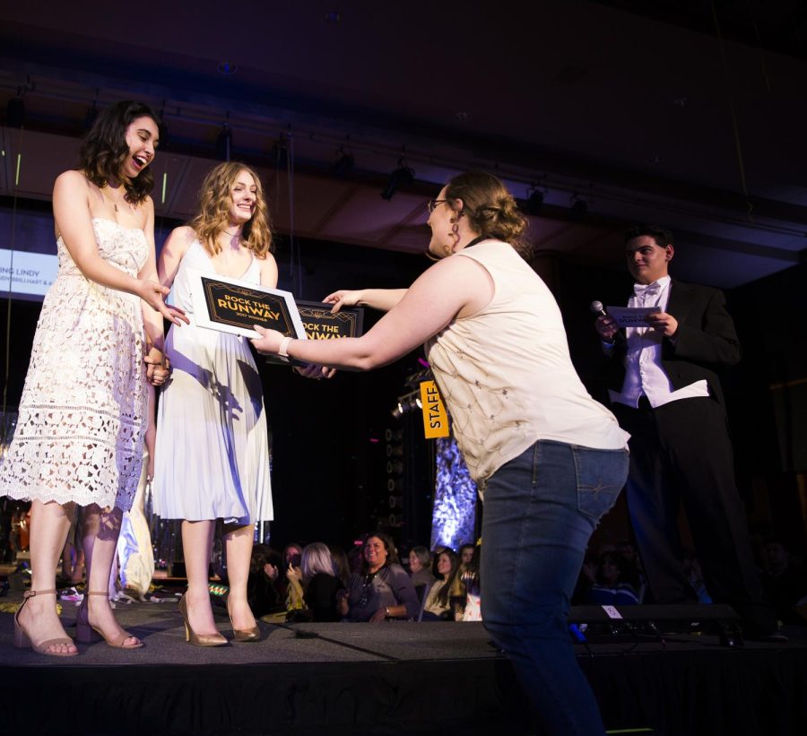 Rebecca Kapler hands the Rock the Runway awards to Ann Marie Elaban and Kassidy Brillhart, designers of the winning line "Living Lindy" on Saturday, March 4, 2017.