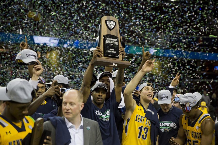 The Kent State Men's Basketball team holds the the MAC Championship trophy after beating Akron 70-65 at Quicken Loans Arena in Cleveland, Ohio on Saturday, March 11, 2017. Kent State punched their ticket to the NCAA Tournament.