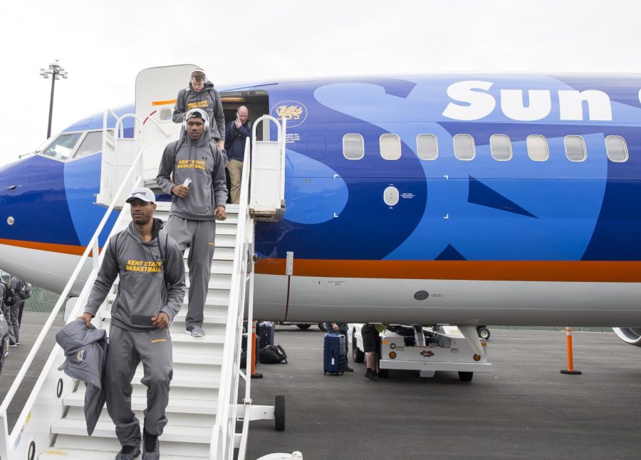 Members of the Kent State men's basketball team and Coach Rob Senderoff exit the team plane at Sacramento International Airport in Sacramento, California, on Wednesday, March 15, 2017.