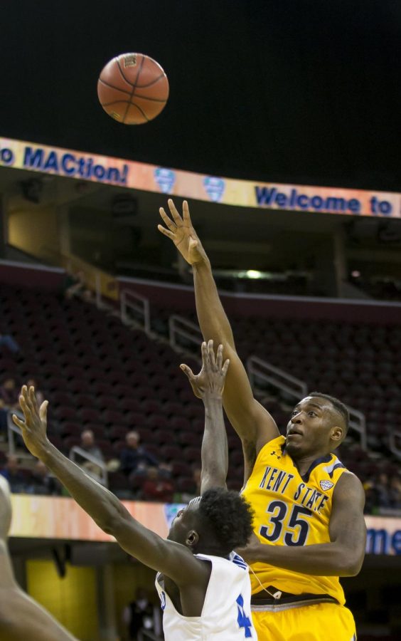 Kent State senior forward Jimmy Hall floats a shot over Buffalo senior forward David Kadiri during the quarterfinals of the MAC Tournament at Quicken Loans Arena in Cleveland, Ohio, on Thursday, March 9, 2017. Kent State won, 68-65.