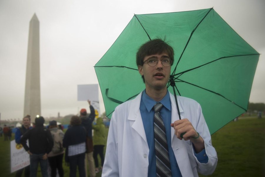 Third-year graduate student David Ruth from New Hampshire stands on the National Mall lawn in Washington, D.C. on Saturday, April 22, 2017. Ruth is working to get his doctorate in nuclear physics. “Publicly funded science has done a lot for us. It's brought us to where we are in modern civilization. I feel a really big draw to be able to understand things that aren't necessarily intuitive. ... Even if you don't make some big discovery, every scientist plays at least some part in expanding our knowledge," Ruth said. 