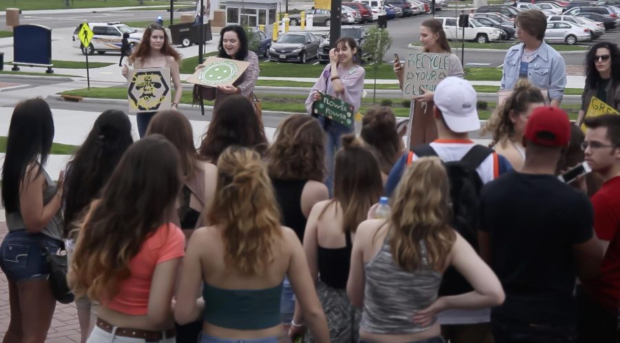 Members of the Global Fashion Citizens student organization inform students waiting in line for the indoor FlashFest concert about the issue of "fast fashion" on Thursday, April 20, 2017.