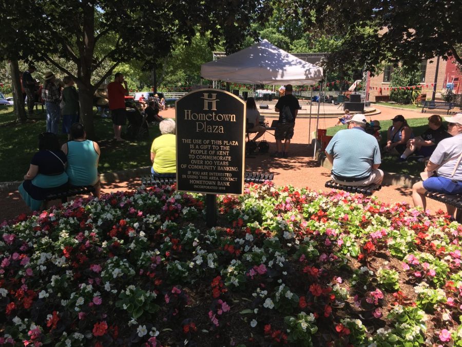 People gather at Hometown Bank Plaza Stage to hear local artists preform during Main Street Kent's 11th annual Wine and Arts Festival on Sat., June 3, 2017.