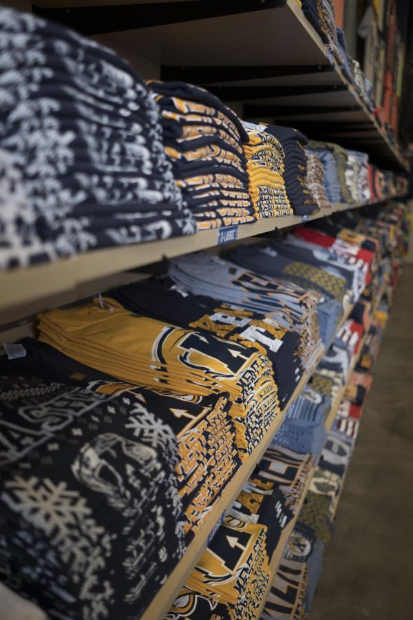 Clothes line the wall at UniversiTEES, all Kent State related, on Saturday, April 15, 2017.