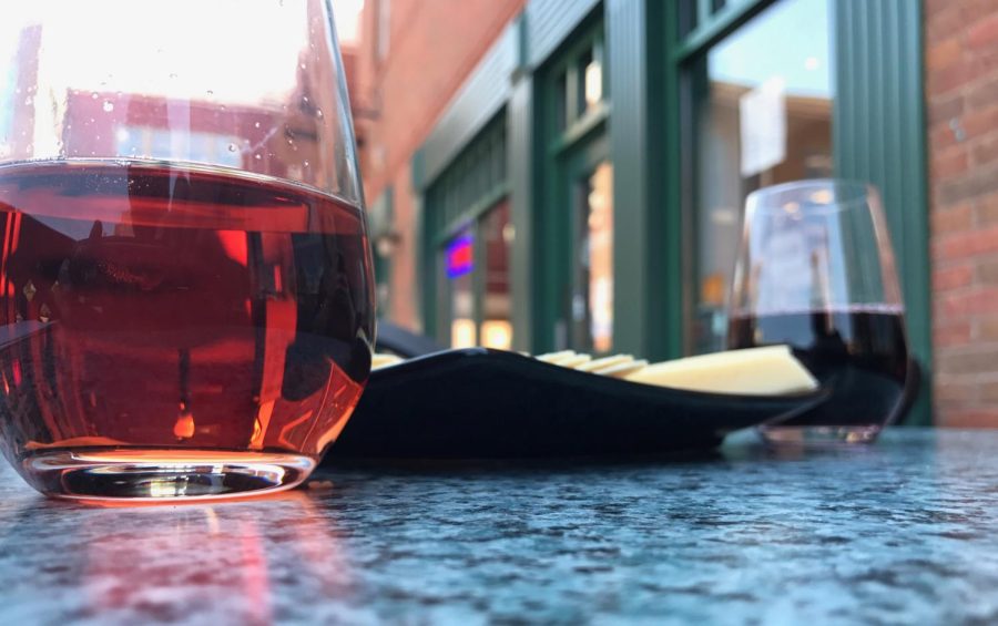 Two glasses from the Kent Cheesemonger accompanied by a lunch plate on Tuesday, August 8, 2017. 