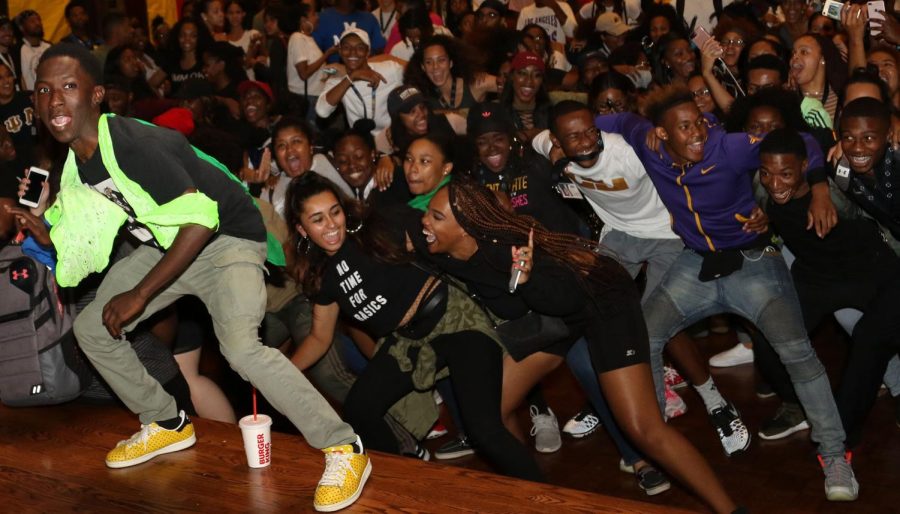 Emonte Wimbush (left), a junior fashion merchandising major, dances on stage while others join behind him during Kupita Transitiones' cultural orientation on Tuesday, Aug. 22, 2017. The four-day event was created to bring transfer and first-year multiracial students together, and help them acclimate to the cultural climate at Kent State. 