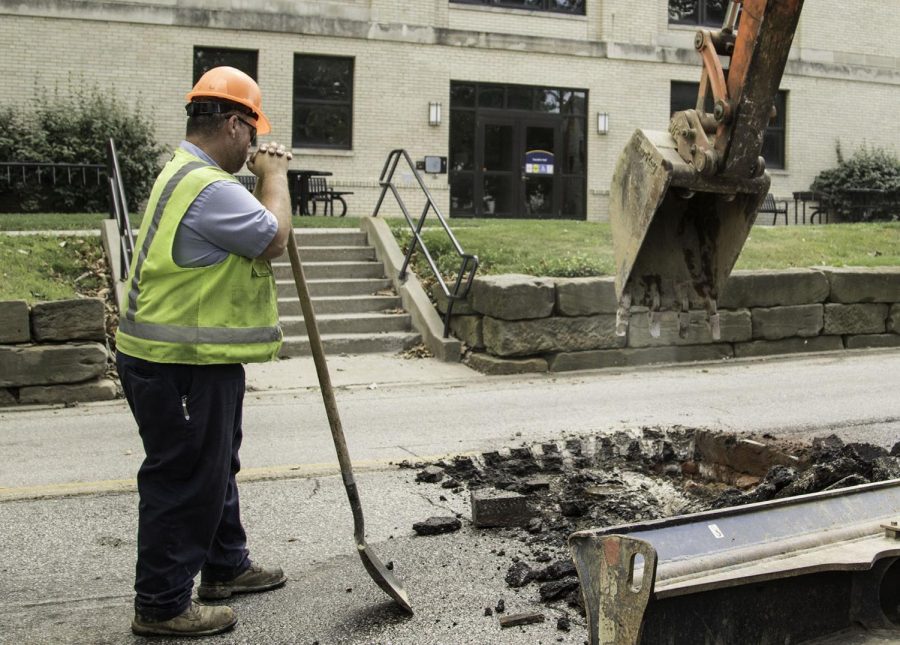 John Kuhns, 48, of Kent, Ohio, inspects a water pipe as he removes a section of pavement near Franklin Hall Wednesday, Aug. 23, 2017.