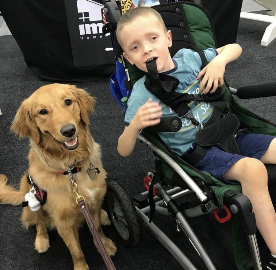 Connor Wright and his dog, Leo, pose for a portrait. 