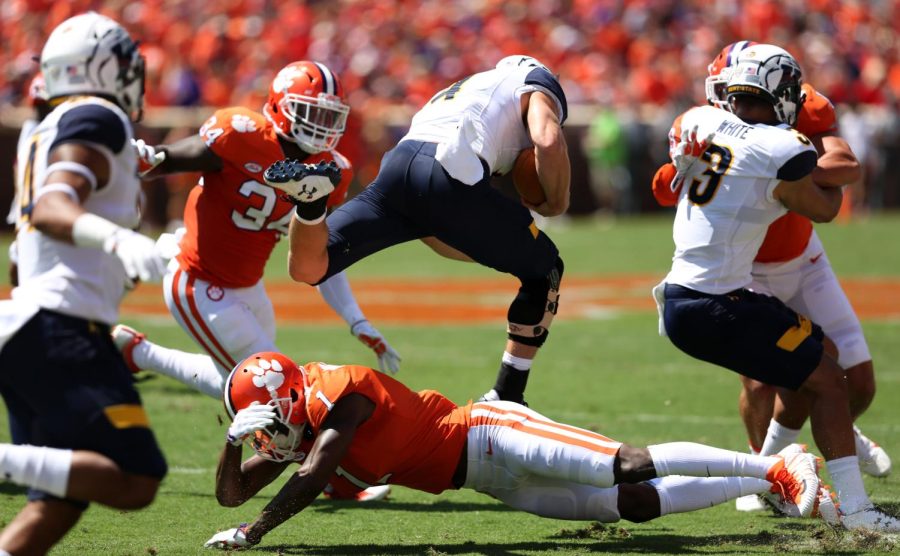 Kent State quarterback Nick Holley hurdles a defender during Kent State's matchup against No. 5 Clemson.