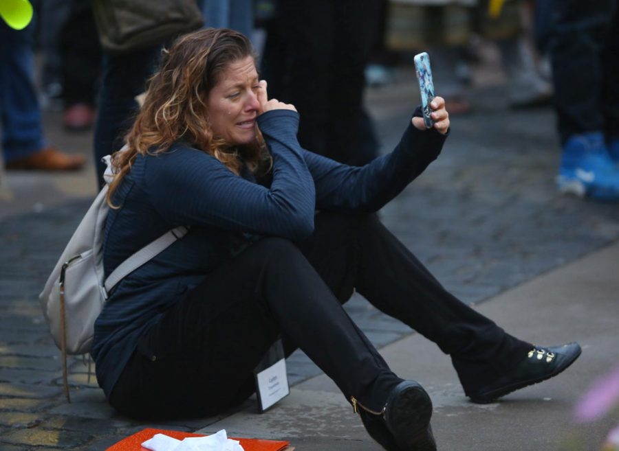 Lynn Tramonte, the deputy director of America's Voice, wipes a tear while a "Dreamer" tells her story at the candlelight vigil.