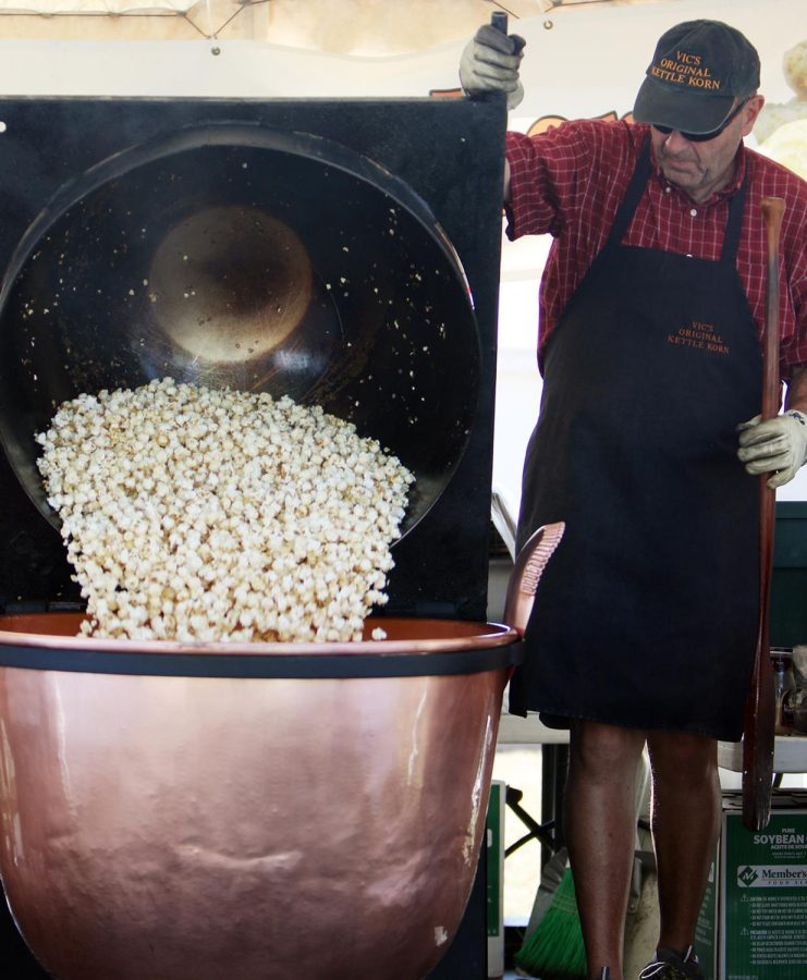 Elden Wells, 62, of Brimfield, Ohio, dumps a popcorn into a copper kettle during Brimfest. After a decade-long scheduling conflict, Wells finally participated in Brimfest. “It’s all about supporting the community,” said Vickie, Elden's wife.