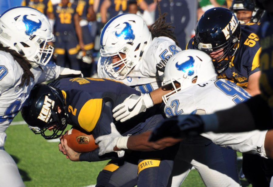 Buffalo defenders tackle Kent State quarterback George Bollas during a run in the third quarter Saturday, Sept. 30, 2017.