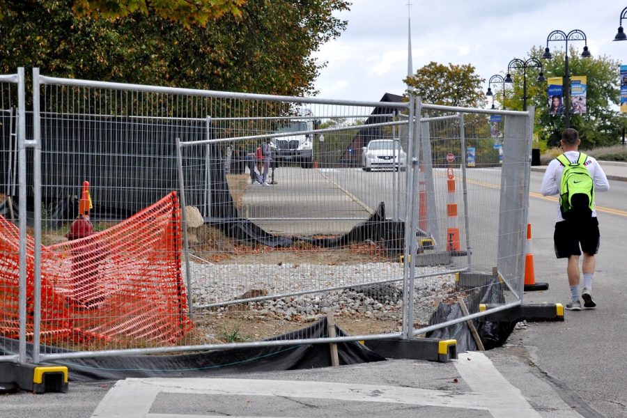 A student is forced to walk outside the cross walk due to construction at the Center for Performing Arts on Thursday, Oct. 5, 2017.