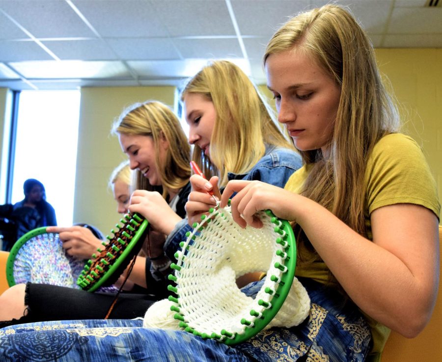 Katherine Mohnacky, a senior early childhood education major (left), Samantha Hunker, a sophomore fashion merchandising major and Zoe Katz, a sophomore fashion merchandising major, enjoyed the opportunity to spend time with one another and help create knitted goods for the homeless Friday, Sept. 29, 2017.