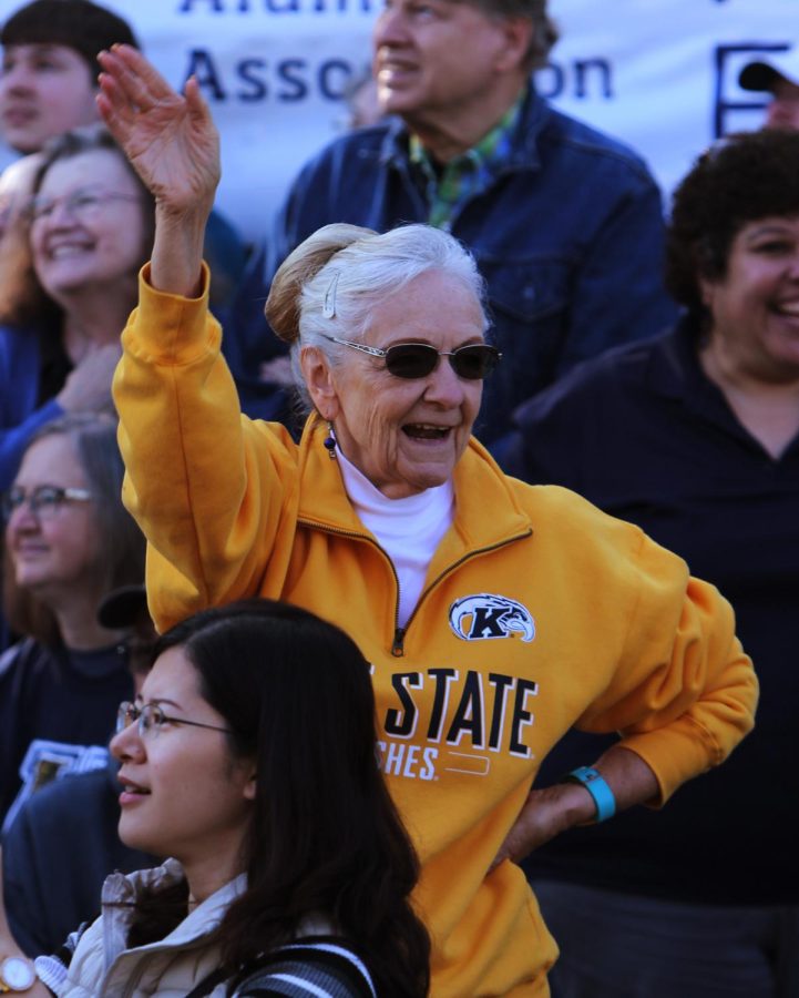 Kay Wise, a ’78 Kent State alumna, cheers during the Homecoming Parade Saturday, Oct. 14, 2017. Wise and her husband, Ralph, attended the Homecoming Parade in 1961 on their first date.