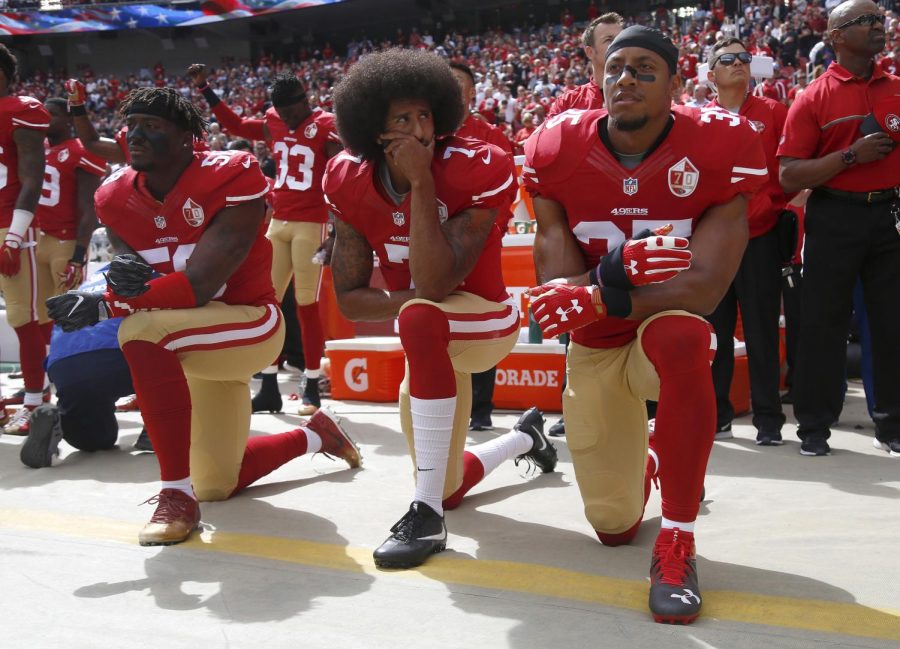 From left, San Francisco 49ers' Eli Harold (58), quarterback Colin Kaepernick (7) and Eric Reid (35) kneel during the national anthem before their NFL game against the Dallas Cowboys on Sunday, Oct. 2, 2016 in Santa Clara, Calif.