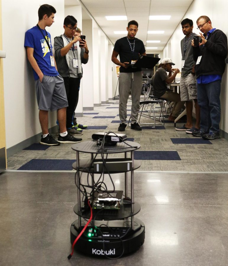 Gilson Dos Santos, a senior computer science major, controls his team’s autonomous flight attendant prototype.