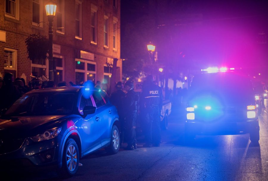 Police talk with partygoers downtown on S. Water Street during Kent Halloween Oct. 28, 2017. 