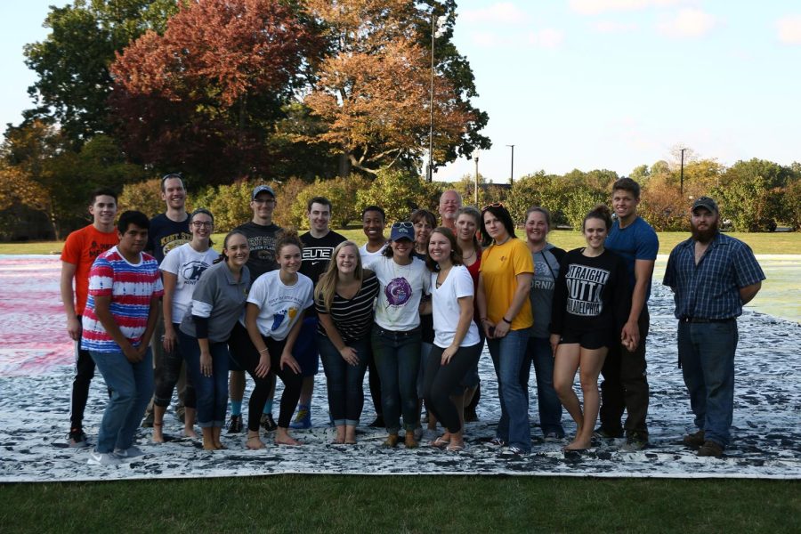 Participants of Kelsey Merritt's foot-painted mural project pose for a photo. Merritt broke the Guinness World Record with 26, 787 square feet Friday, Oct. 13, 2017.