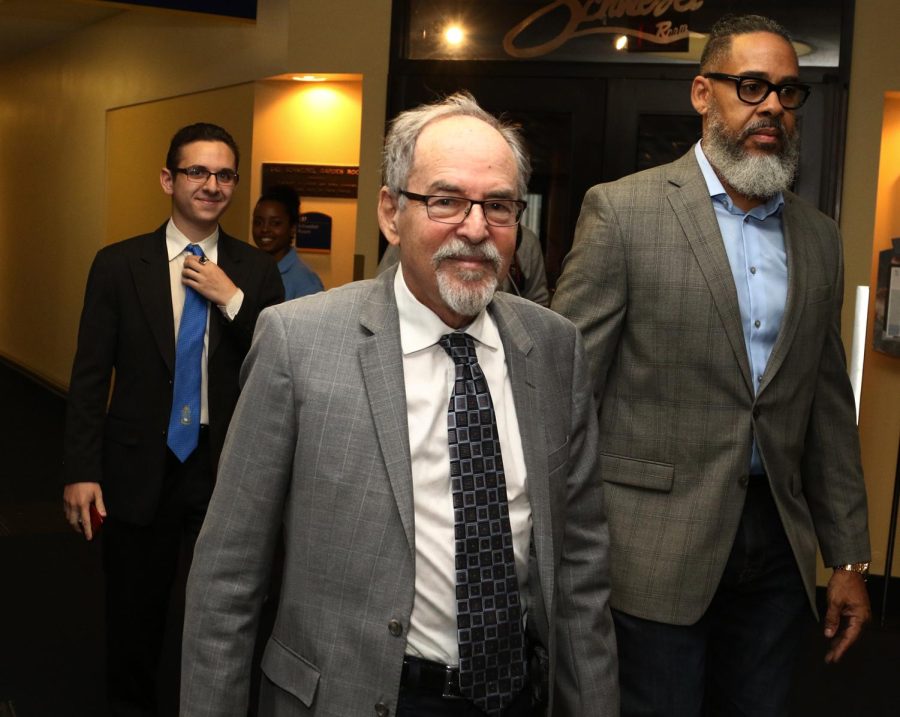 David Horowitz walks toward the room on the third floor of the Student Center where he will deliver a speech.