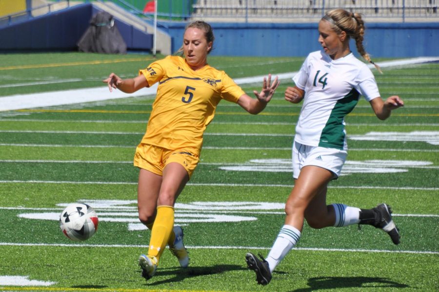 Kent forward Hayden Pascoe and EMU defender Tessa Osborne race for the ball during the game on Sunday, Sept. 24, 2017.