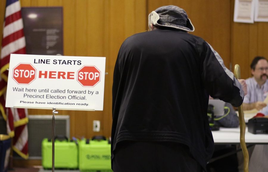 Voters wait in line to check into the Kent United Church of Christ polling station Tuesday, Nov. 7, 2017.