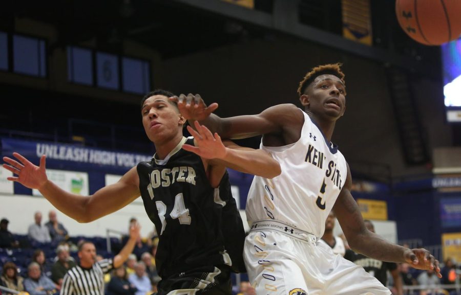 Wooster senior forward Alex Baptiste and Kent State sophomore forward Danny Pippen battle for the ball during an exhibition game in the M.A.C. Center Friday, Nov. 3, 2017.