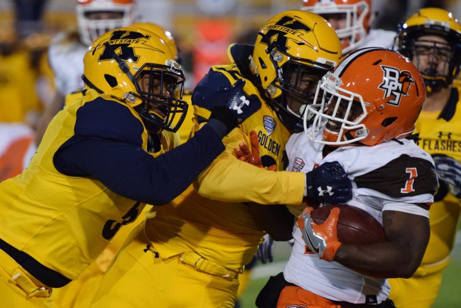 Kent State linebacker James Alexander (left) and safety Erik Simpson attempt to push Bowling Green wide receiver Calvin Clater out of bounds Tuesday, Oct. 31, 2017.