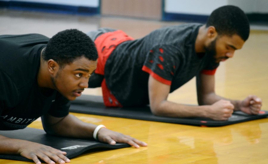 Freshman construction management major Jason Booker and freshman digital media production major Peter Lindo concentrate as they do their planks Saturday, Dec. 2, 2017, an activity part of the Big Brotha's Program.