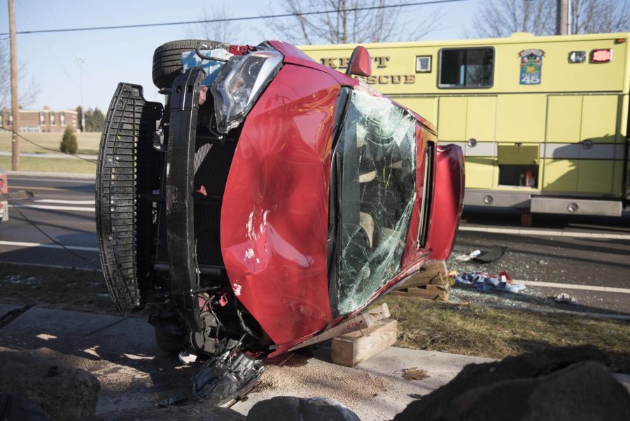 A car flipped after hitting a pedestrian sign and large rock Friday, Jan. 26, 2018.