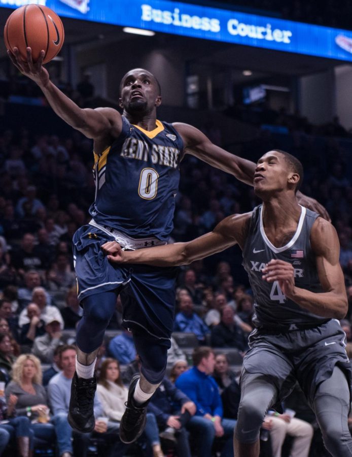 Kent State junior guard Jalen Avery drives to the hoop against Xavier freshman guard Elias Harden during Kent State's 96-70 loss to Xavier Wednesday, Dec. 6, 2017. 