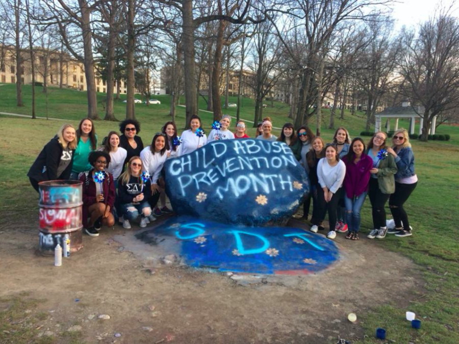 Members of Sigma Delta Tau gather around the Rock on Kent's campus