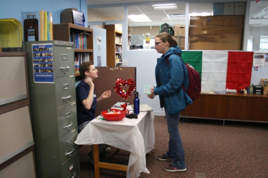 Madeline Steward explaining Valentine’s Day tradition at the Italy booth.